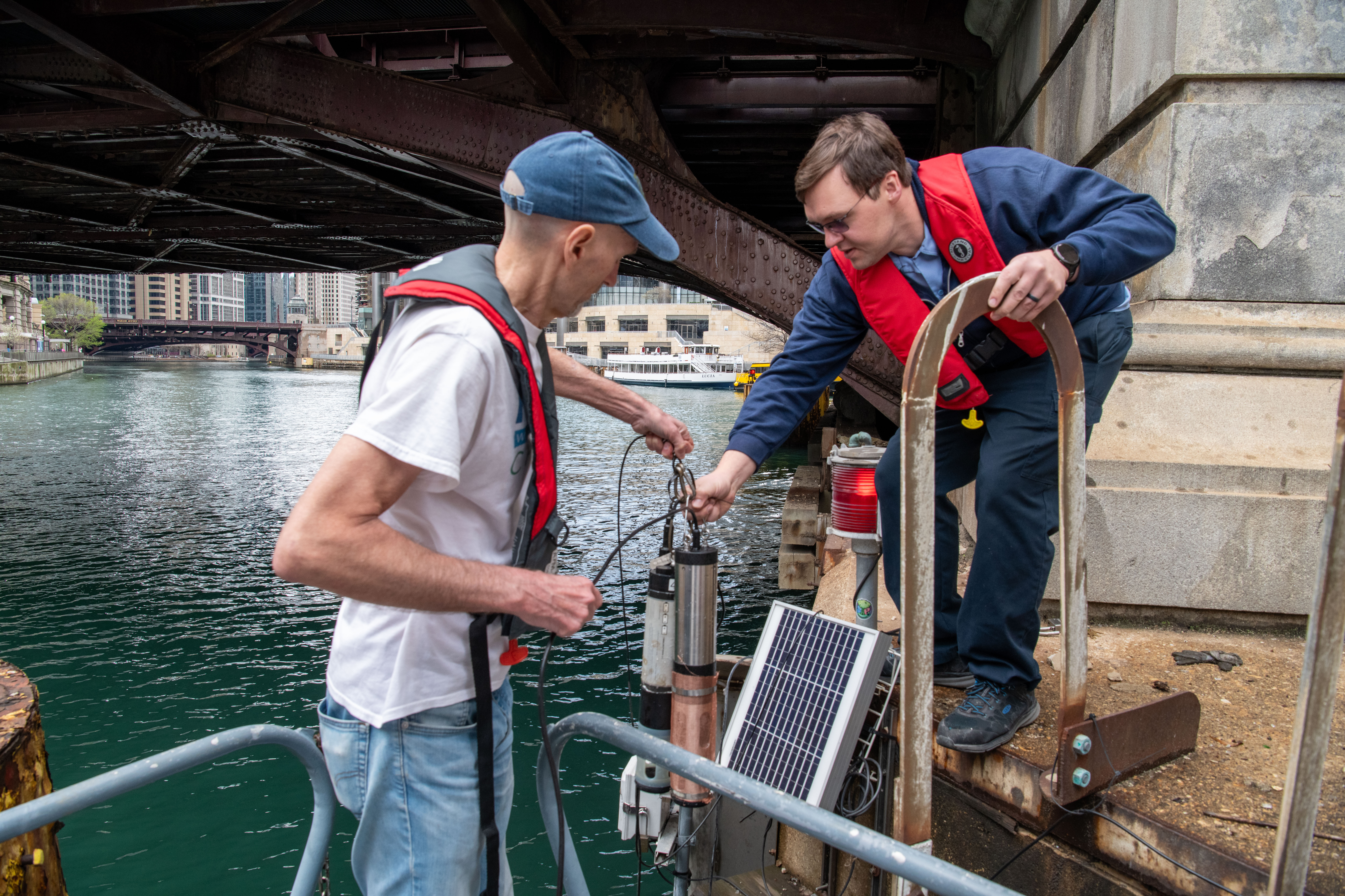 Current and MWRD staff installing an H2NOW sonde in the Chicago River